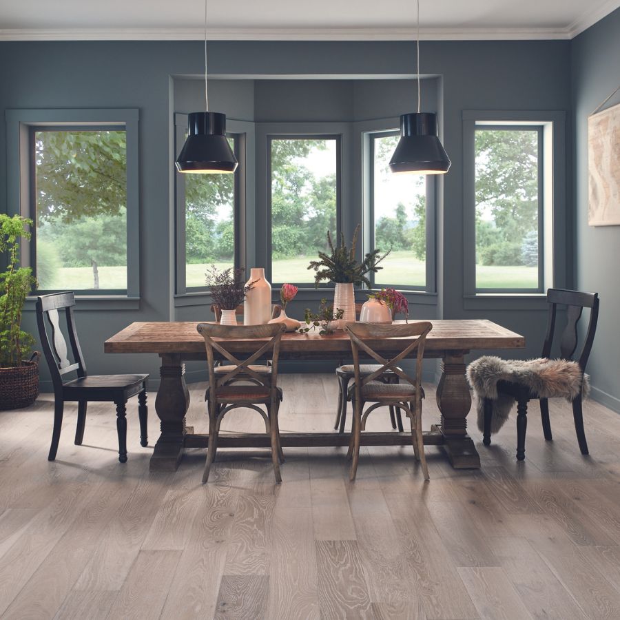 wide plank hardwood flooring in dining room with wood table and chairs