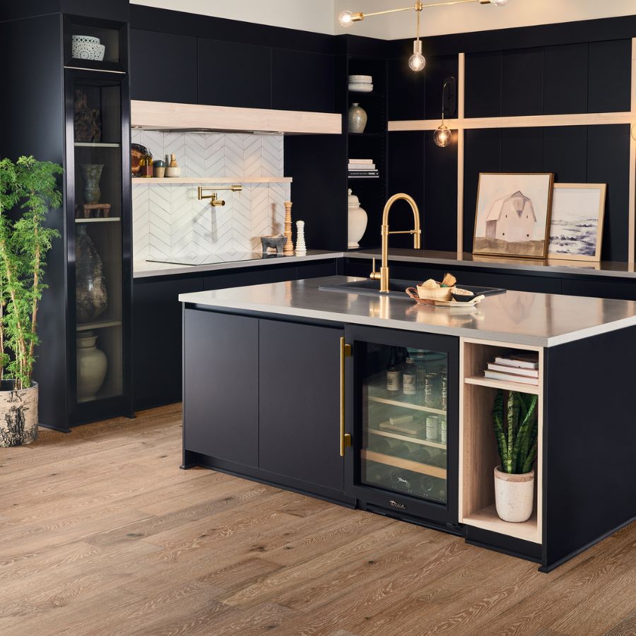 hardwood flooring in kitchen with dark navy cabinets and gold fixtures